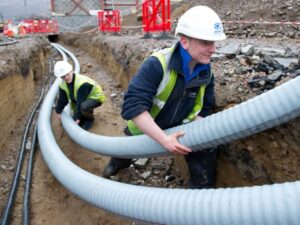 Workers install the flexible, pre-insulated heat pipes used in district heating [Photo courtesy Warmtenetwerk]